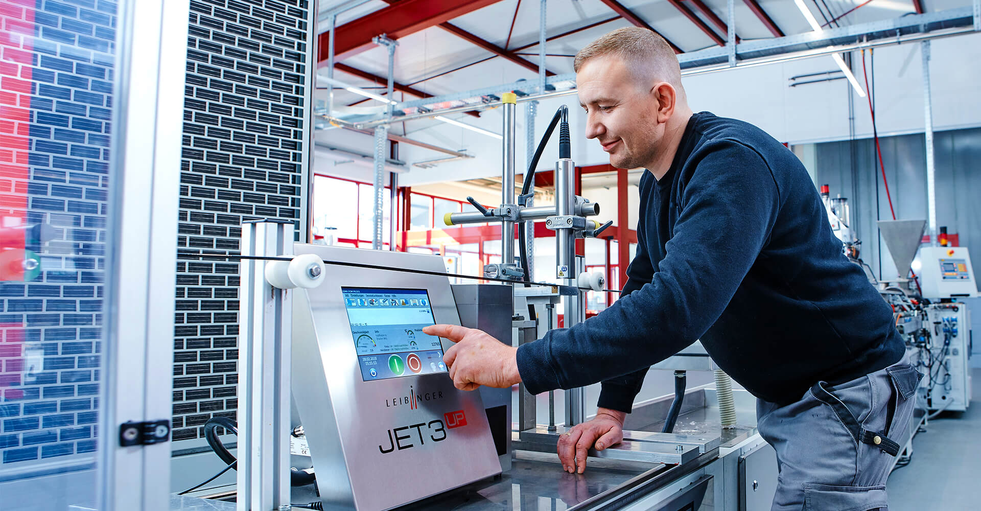 Man uses a Continuous inkjet printer and smiles.